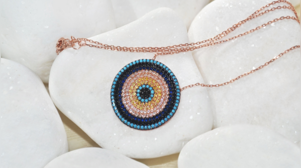 A person contemplating the two interpretations of the Evil Eye.