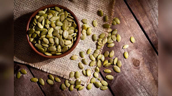 A handful of green, nutrient-rich pumpkin seeds.
