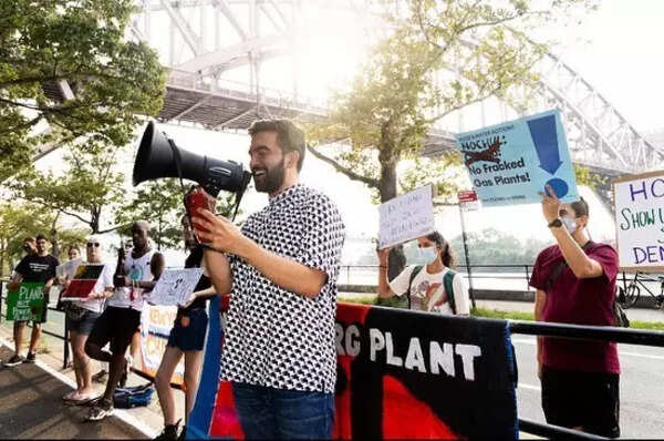 Zohran Mamdani in smart casual attire at a rally